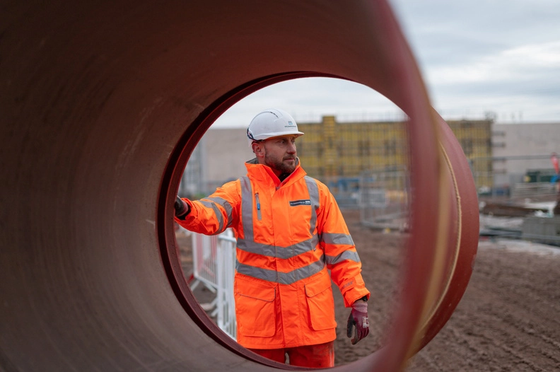 Worker In PPE on construction site looking in to the distance