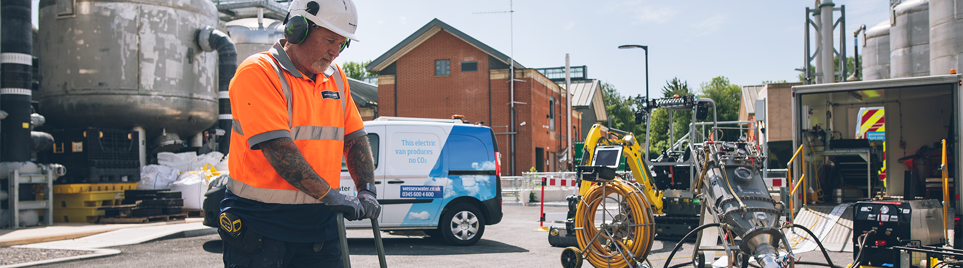 Wessex Water worker on site suing equipment and wearing PPE