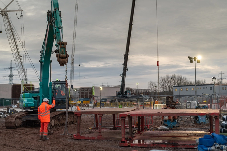 Worker with crane pointing with hand in the air